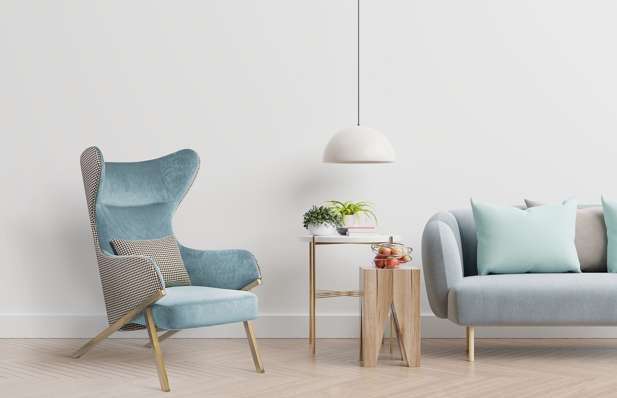 Empty living room with blue sofa, plants and table on empty white wall background. 3D rendering